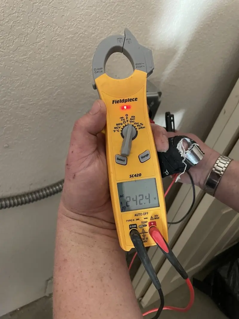 Voltage testing with clamp meter during Outlet Installation in Killeen